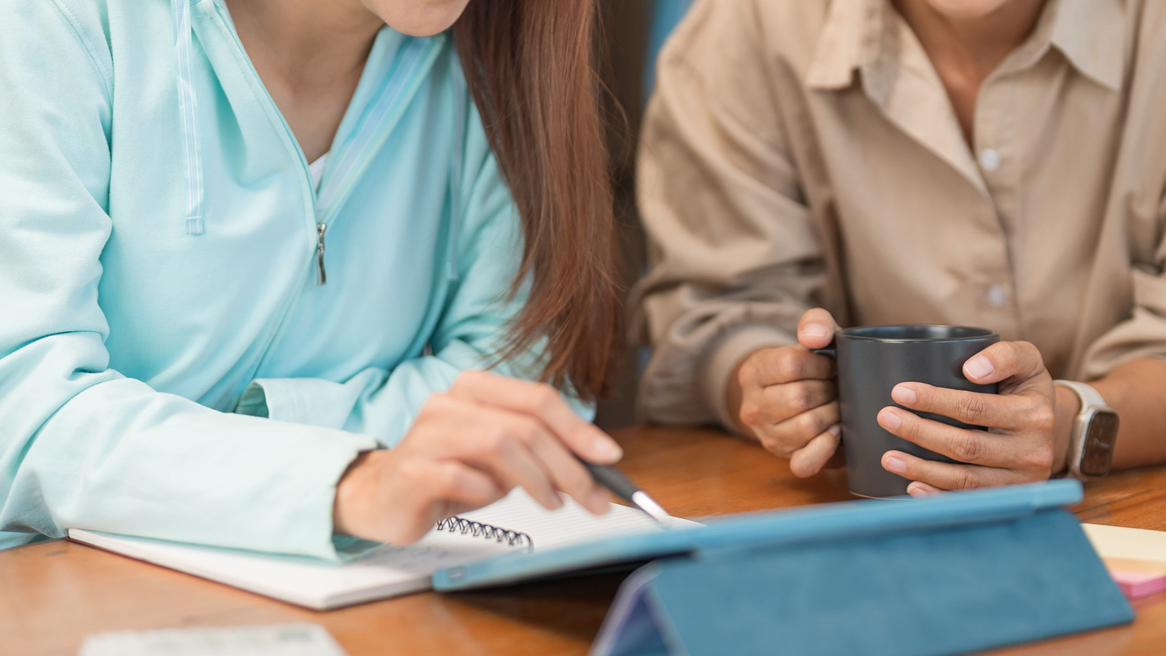 College education concept, Teenage girl pointing homework on tablet to asking question with tutor.